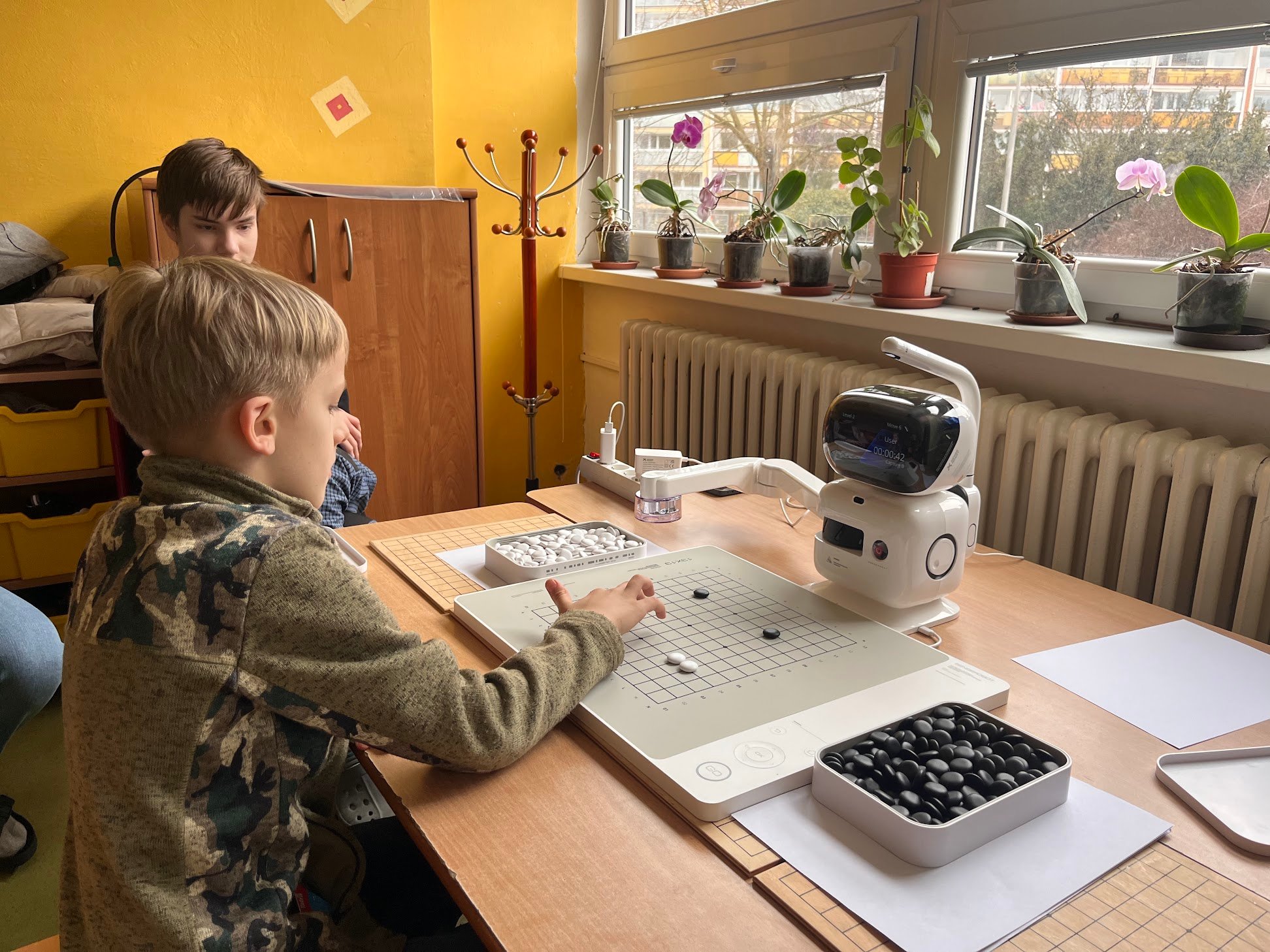 Dítě hraje go proti robotovi